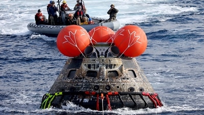 NASA's Orion capsule is drawn to the well deck of the U.S.S. Portland after it splashed down following a successful uncrewed Artemis I Moon Mission on December 11 in the Pacific Ocean off the coast of Baja California, Mexico. (Mario Tama / REUTERS) NASA's Orion capsule is drawn to the well deck of the U.S.S. Portland after it splashed down following a successful uncrewed Artemis I Moon Mission on December 11 in the Pacific Ocean off the coast of Baja California, Mexico. (Mario Tama / REUTERS)