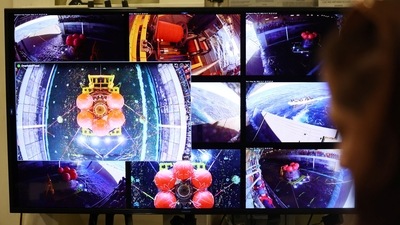 Video feeds displayed after NASA's Orion capsule was brought into the well deck of the U.S.S. Portland following a successful uncrewed Artemis I Moon Mission, seen from aboard the Portland on December 11. The incoming capsule hit the atmosphere at Mach 32, or 32 times the speed of sound, and endured reentry temperatures of 5,000 degrees Fahrenheit (2,760 degrees Celsius) before splashing down west of Baja California near Guadalupe Island, AP reported. (Mario Tama / REUTERS) Video feeds displayed after NASA's Orion capsule was brought into the well deck of the U.S.S. Portland following a successful uncrewed Artemis I Moon Mission, seen from aboard the Portland on December 11. The incoming capsule hit the atmosphere at Mach 32, or 32 times the speed of sound, and endured reentry temperatures of 5,000 degrees Fahrenheit (2,760 degrees Celsius) before splashing down west of Baja California near Guadalupe Island, AP reported. (Mario Tama / REUTERS)