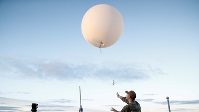 An Air Force member releases a weather balloon off the deck of the U.S.S. Portland (LPD 27) as part of the recovery operation for the Orion capsule off the coast of Baja California, Mexico, on December 11. A Navy ship quickly moved in to recover the spacecraft and its silent occupants — three test dummies rigged with vibration sensors and radiation monitors. (Caroline Brehman / REUTERS) An Air Force member releases a weather balloon off the deck of the U.S.S. Portland (LPD 27) as part of the recovery operation for the Orion capsule off the coast of Baja California, Mexico, on December 11. A Navy ship quickly moved in to recover the spacecraft and its silent occupants — three test dummies rigged with vibration sensors and radiation monitors. (Caroline Brehman / REUTERS)