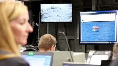Video screens in the USS Portland command center show live feeds of the recovery operations as NASA's Orion Capsule splashes in the Pacific Ocean off the coast of Baja California, Mexico, on December 11. “I'm overwhelmed,” NASA Administrator Bill Nelson told AP from Mission Control in Houston. “This is an extraordinary day ... It's historic because we are now going back into space — deep space — with a new generation.” (Mario Tama / AFP) Video screens in the USS Portland command center show live feeds of the recovery operations as NASA's Orion Capsule splashes in the Pacific Ocean off the coast of Baja California, Mexico, on December 11. “I'm overwhelmed,” NASA Administrator Bill Nelson told AP from Mission Control in Houston. “This is an extraordinary day ... It's historic because we are now going back into space — deep space — with a new generation.” (Mario Tama / AFP)
