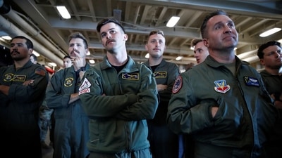 HSC-23 Navy flight crew members watch as NASA's Orion capsule floats in the well deck after being successfully secured by a NASA and US Navy team, off the coast of Baja California, Mexico, on December 11. (Caroline Brehman / REUTERS) HSC-23 Navy flight crew members watch as NASA's Orion capsule floats in the well deck after being successfully secured by a NASA and US Navy team, off the coast of Baja California, Mexico, on December 11. (Caroline Brehman / REUTERS)