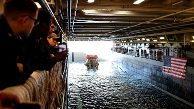 Crew members gather after NASA's Orion Capsule was brought into the well deck of the U.S.S. Portland, in the Pacific Ocean off the coast of Baja California, Mexico on December 11. “From Tranquility Base to Taurus-Littrow to the tranquil waters of the Pacific, the latest chapter of NASA's journey to the moon comes to a close. Orion back on Earth,” announced Mission Control commentator Rob Navias as reported by AP. (Mario Tama / REUTERS) Crew members gather after NASA's Orion Capsule was brought into the well deck of the U.S.S. Portland, in the Pacific Ocean off the coast of Baja California, Mexico on December 11. “From Tranquility Base to Taurus-Littrow to the tranquil waters of the Pacific, the latest chapter of NASA's journey to the moon comes to a close. Orion back on Earth,” announced Mission Control commentator Rob Navias as reported by AP. (Mario Tama / REUTERS)