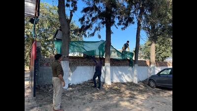 A net being put up on the boundary wall of a police post in Mohali on Monday. A net being put up on the boundary wall of a police post in Mohali on Monday.