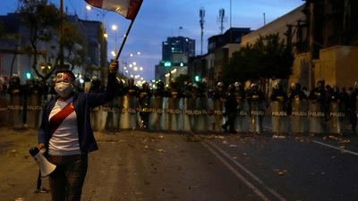 Protests In Peru: A supporter of ousted President Pedro Castillo holds a Peruvian flag near Congress in Lima, Peru. (AP)