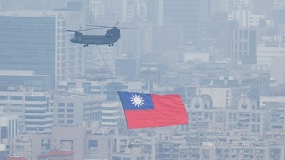 China-Taiwan Conflict: A Chinook helicopter carrying a Taiwan flag flies over the city during the country's National Day celebration in Taipei, Taiwan. (Reuters)