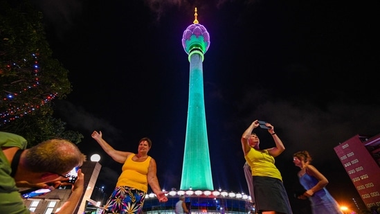 Tourists take pictures in front of the Sri Lankan 'white elephant' Chinese-built Lotus Tower after it was opened for public in Colombo, Sri Lanka. India, Sri Lanka resume flights between Chennai and Jaffna, 3 years after Covid-19 (Photo by Ishara S. KODIKARA / AFP) Tourists take pictures in front of the Sri Lankan 'white elephant' Chinese-built Lotus Tower after it was opened for public in Colombo, Sri Lanka. India, Sri Lanka resume flights between Chennai and Jaffna, 3 years after Covid-19 (Photo by Ishara S. KODIKARA / AFP)
