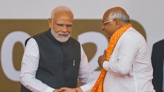 Prime Minister Narendra Modi being greeted by BJP leader Bhupendra Patel during the latter's oath-taking ceremony as Gujarat Chief Minister, in Gandhinagar on Monday(PTI)