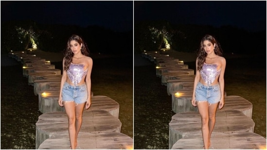 Janhvi decked up in a violet off-shoulder satin cropped top with a V-shaped detail at the waist, perfectly hugging her curves and showing off her midriff. The top also featured details in white and ochre shade.&nbsp;(Instagram/@janhvikapoor)