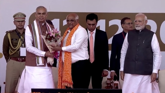 Gujarat Governor Acharya Devvrat hands a bouquet to BJP leader Bhupendra Patel during his&nbsp;oath-taking ceremony as Gujarat Chief Minister.&nbsp;Prime Minister Narendra Modi in picture.(source:Twitter/@BJP4India)