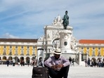 Portugal Golden Visa: A tourist rests at Comercio square in downtown Lisbon, Portugal.