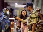 Passengers make an enquiry from security personnel at a terminal at the Chennai Airport on Tuesday.(PTI) Passengers make an enquiry from security personnel at a terminal at the Chennai Airport on Tuesday.(PTI)