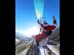 'Santa' and his dog seen paragliding from a mountain.(Instagram/@ouka.sam) 'Santa' and his dog seen paragliding from a mountain.(Instagram/@ouka.sam)