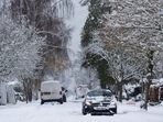 A car moves along a snow covered road in Shenfield, UK, on Monday. A car moves along a snow covered road in Shenfield, UK, on Monday.