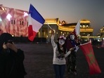 Women hold flags from France, Morocco and Qatar at Katara Cultural Village in Doha, Qatar, Sunday, Dec. 11, 2022. (AP) Women hold flags from France, Morocco and Qatar at Katara Cultural Village in Doha, Qatar, Sunday, Dec. 11, 2022. (AP)