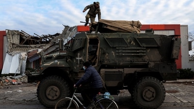 A man rides past an American MaxxPro military vehicle in the formerly Russian occupied city of Lyman, Donetsk region of Ukraine, on December 11. Fierce fighting in the region in recent weeks has left unclear which parts of Donetsk are under Russian and Ukrainian control, Reuters reported. (Shannon Stapleton / REUTERS) A man rides past an American MaxxPro military vehicle in the formerly Russian occupied city of Lyman, Donetsk region of Ukraine, on December 11. Fierce fighting in the region in recent weeks has left unclear which parts of Donetsk are under Russian and Ukrainian control, Reuters reported. (Shannon Stapleton / REUTERS)