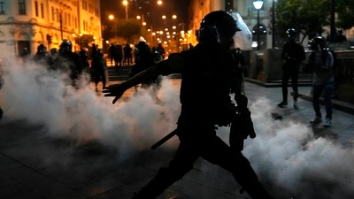 Protests In Peru: Tear gas is returned to police trying to break up supporters of ousted President Pedro Castillo at plaza San Martin in Lima, Peru. (AP)