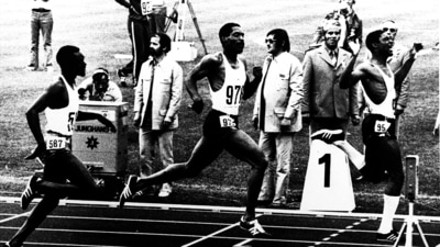 FILE - United States' Vince Matthews, right, raises his arms as he wins the final of the Olympic Games 400-meter dash, edging out teammate Wayne Collett, center. Julius Sang, left, of Kenya, finished third on Sept 7, 1972 in Munich. The International Olympic Committee says it will allow American gold-medal sprinter Matthews back at the games more than 50 years after banning him for his low-key racial injustice protest at the Munich Olympics. (AP Photo, File) (AP)