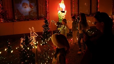 People of all age groups come in droves to Haines's home in the coastal town of Fish Hoek to see the house that has been decked with more than 2,00,000 lights for Christmas.&nbsp; (REUTERS)