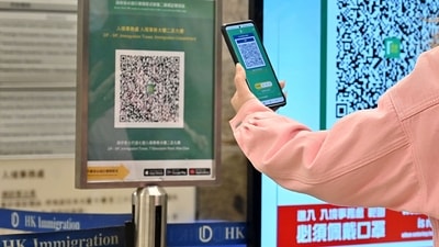 The government will lift a ban on international arrivals and people will not have to scan a QR code on their phones to enter certain venues, said Chief Executive John Lee at a press conference on Tuesday. (AFP) The government will lift a ban on international arrivals and people will not have to scan a QR code on their phones to enter certain venues, said Chief Executive John Lee at a press conference on Tuesday. (AFP)