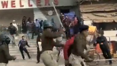 Hundreds of police personnel can be seen chasing the protestors and beating them with sticks and batons (Twitter Photo)