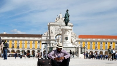 Portugal Golden Visa: A tourist rests at Comercio square in downtown Lisbon, Portugal. (Reuters)