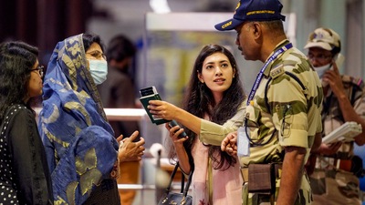 Passengers make an enquiry from security personnel at a terminal at the Chennai Airport on Tuesday. (PTI) Passengers make an enquiry from security personnel at a terminal at the Chennai Airport on Tuesday. (PTI)