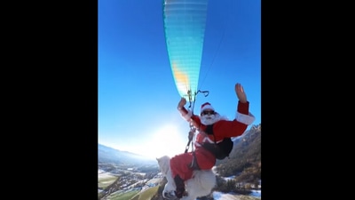 'Santa' and his dog seen paragliding from a mountain. (Instagram/@ouka.sam) 'Santa' and his dog seen paragliding from a mountain. (Instagram/@ouka.sam)