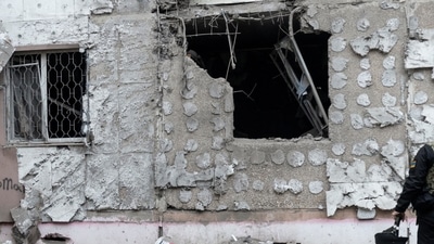 Russia-Ukraine War: A Ukrainian war crime prosecutor inspects a residential building damaged by a Russian military strike, amid Russia's attack on Ukraine continues, in Kherson. (Reuters)