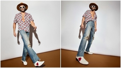 In the end, Ranveer styled the ensemble with diamond ear studs, a sleek chain with a guitar pick pendant, a trimmed beard and back swept hairdo. (Instagram) In the end, Ranveer styled the ensemble with diamond ear studs, a sleek chain with a guitar pick pendant, a trimmed beard and back swept hairdo. (Instagram)