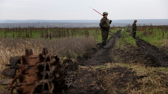 Olexandr, 41, and Petro, 50, members of the Ukrainian National guard demining team Battalion Dnipro 1, walk in mine fields, in the northern part of the Donetsk region, on December 12. Russia has claimed to be gradually advancing its positions, with the defence ministry saying on December 12 that its offensive there had killed 30 Ukrainian military personnel the day before, Reuters reported.&nbsp;(Shannon Stapleton / REUTERS)