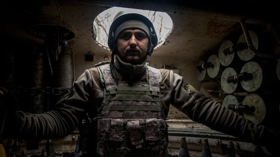A Ukrainian artilleryman from the 24th brigade stands inside of a 2S1 Gvozdika self-propelled howitzer along the front line in the vicinity of Bakhmut, Donetsk region, on December 10. The General Staff of Ukraine's Armed Forces said its forces had repelled a Russian attack on the frontline town, Reuters reported.(Ihor Tkachov / AFP)