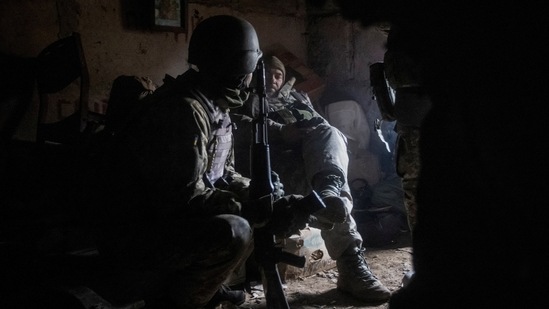 Ukrainian service members rest in their shelter in Bakhmut, Donetsk region, on December 9. Russia's sustained shelling of the frontline in Donetsk has completely destroyed the city of Bakhmut and heavily damaged the city of Avdiivka, which lies in the region's centre, Ukraine's President Volodymyr Zelenskiy said on December 9.(Yevhen Titov / REUTERS)