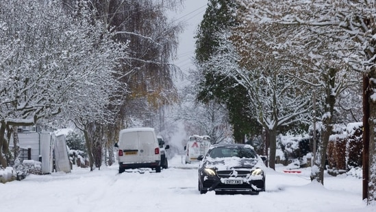 A car moves along a snow covered road in Shenfield, UK, on Monday. (Bloomberg)