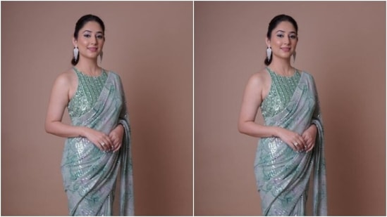 Disha further teamed her saree with a sleeveless pastel green blouse featuring a closed neckline, silver sequin details and embellishments. (Instagram/@dishaparmar)