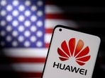 Huawei: Smartphone with a Huawei logo is seen in front of a US flag in this illustration taken in 2021.