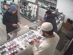 The thief sporting a hoodie and disguising as a customer.