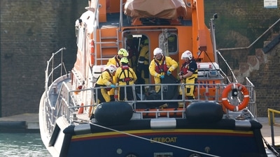 British Channel Incident: Rescue workers handle what appears to be a body bag, as they return to the Port of Dover. (Reuters)