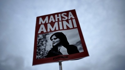 Iran Anti-Hijab Protests: A woman holds a placard with a picture of Iranian woman Mahsa Amini during a protest against her death. (AP) Iran Anti-Hijab Protests: A woman holds a placard with a picture of Iranian woman Mahsa Amini during a protest against her death. (AP)