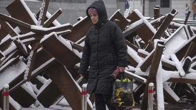 Russia-Ukraine War: A woman passes by anti-tank hedgehogs in central Kyiv, Ukraine. (AP)