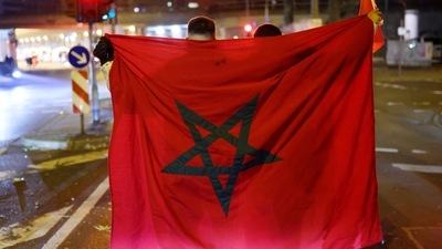 Morocco fans with a flag after the match as Morocco are eliminated from the World Cup. (REUTERS)