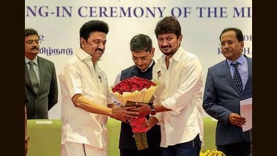 Tamil Nadu Chief Minister MK Stalin presents a bouquet to DMK MLA Udhayanidhi Stalin during the latter's swearing-in ceremony as Tamil Nadu Minister, at Raj Bhavan in Chennai. (PTI) Tamil Nadu Chief Minister MK Stalin presents a bouquet to DMK MLA Udhayanidhi Stalin during the latter's swearing-in ceremony as Tamil Nadu Minister, at Raj Bhavan in Chennai. (PTI)