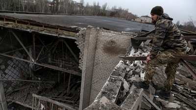 Russia-Ukraine War: A Ukrainian soldier stands on the roof of a damaged university. (Reuters)