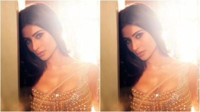 Mouni looked every bit stunning in the sheer golden chiffon saree featuring silver sequin details and a golden border. She teamed her saree with a sleeveless blouse featuring heavy embellishments in golden pearls. (Instagram/@imouniroy) Mouni looked every bit stunning in the sheer golden chiffon saree featuring silver sequin details and a golden border. She teamed her saree with a sleeveless blouse featuring heavy embellishments in golden pearls. (Instagram/@imouniroy)