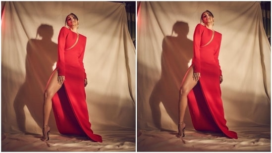 The ensemble features a round neckline, padded shoulders, full-length sleeves with ornate gold buttoned cuffs, a cut-out on the front flaunting her décolletage and midriff, a figure-skimming silhouette, floor-sweeping hem length, and a risqué high slit on the side exposing Malaika's leg.(Instagram)