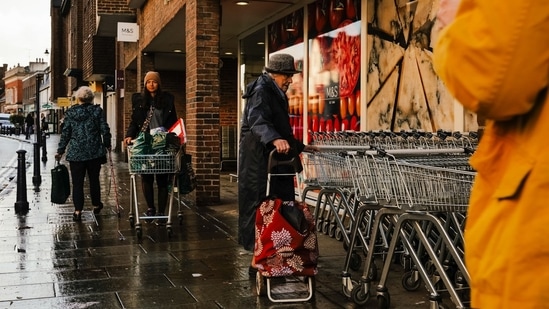 UK Inflation: Shoppers outside a Marks and Spencer Group Plc store in Reigate, UK.(Bloomberg)