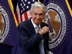 Federal Reserve Board Chairman Jerome Powell leaves after a news conference following the announcement that the Federal Reserve raised interest rates by half a percentage point, at the Federal Reserve Building in Washington.
