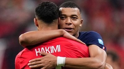 France's Kylian Mbappe hugs Morocco's Achraf Hakimi at the end of the World Cup semifinal soccer match between France and Morocco at the Al Bayt Stadium in Al Khor, Qatar, Wednesday, Dec. 14, 2022. France won 2-0 and will play Argentina in Sunday's final. (AP)