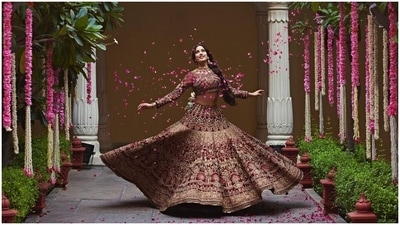 The last image looks like a scene straight out of a period movie. Janhvi slipped into a maroon and gold heavily embroidered lehenga and full-sleeved blouse set for the click. The actor styled it with a gold choker necklace, bangles, earrings, long braided hairdo, bindi, maroon lip shade, and gorgeous makeup picks. (Instagram) The last image looks like a scene straight out of a period movie. Janhvi slipped into a maroon and gold heavily embroidered lehenga and full-sleeved blouse set for the click. The actor styled it with a gold choker necklace, bangles, earrings, long braided hairdo, bindi, maroon lip shade, and gorgeous makeup picks. (Instagram)