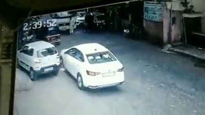 Mumbai man makes narrow escape after being knocked down by bus. Mumbai man makes narrow escape after being knocked down by bus.