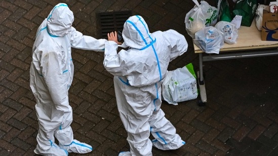 Covid In China: Security guards at the entrance of a compound under Covid-19 lockdown in the Jing'an district in Shanghai.(AFP) Covid In China: Security guards at the entrance of a compound under Covid-19 lockdown in the Jing'an district in Shanghai.(AFP)